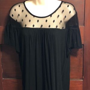 Black top with sheer polka dots at the top